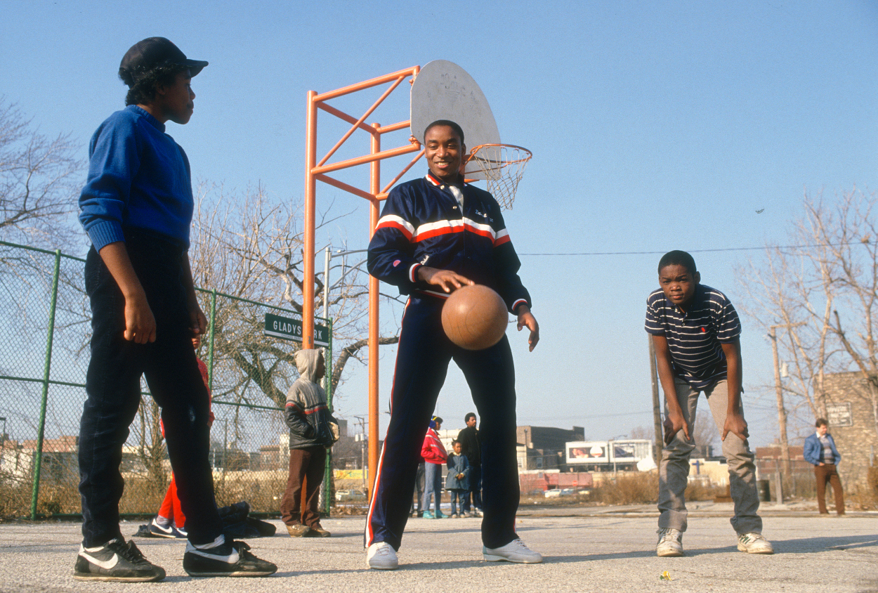 Isiah Thomas of the Detroit Pistons plays a pick up basketball game with kids circa 1987.
