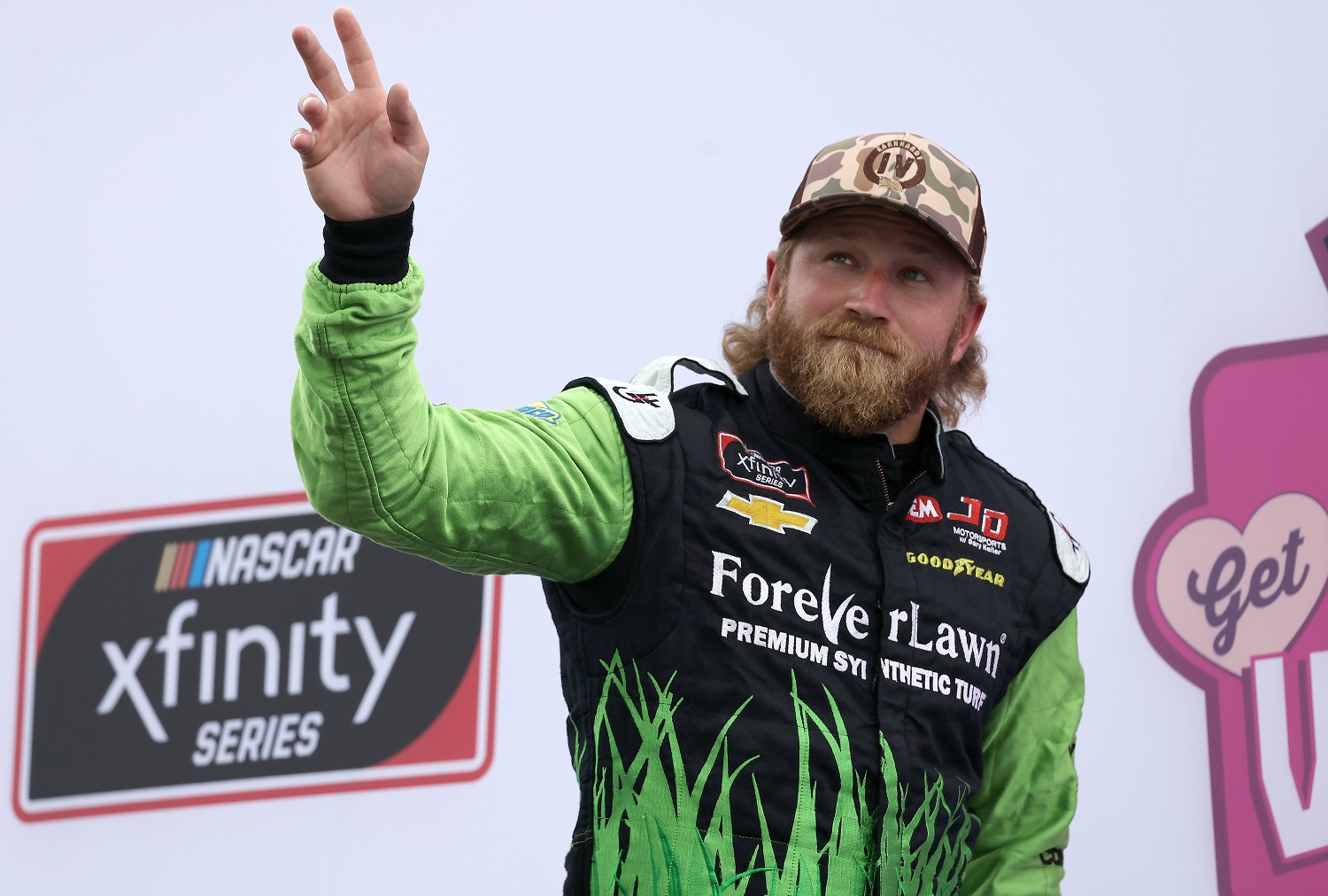 Jeffrey Earnhardt, driver of the No. 0 Chevrolet, waves to fans on stage during ceremonies prior to the NASCAR Xfinity Series Ambetter Get Vaccinated 200 at New Hampshire Motor Speedway on July 17, 2021.