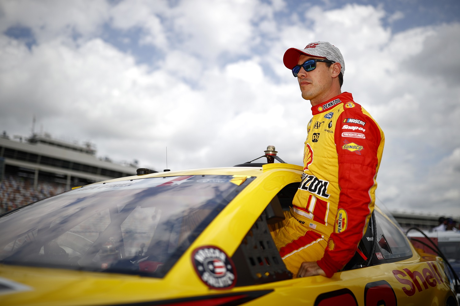 Joey Logano, driver of the No. 22 Ford, enters his car during qualifying for the NASCAR Cup Series Coca-Cola 600 at Charlotte Motor Speedway on May 29, 2021.