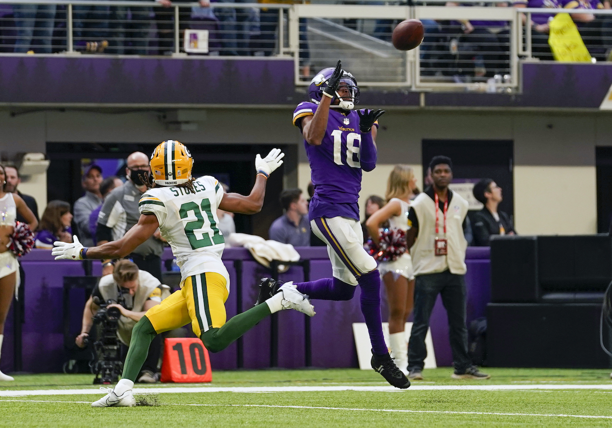 Minnesota Vikings Wide Receiver Justin Jefferson catches a pass from Minnesota Vikings Quarterback Kirk Cousins as Green Bay Packers Cornerback Eric Stokes defends before making his way to the end zone for a 23-yard touchdown reception during a game between the Minnesota Vikings and Green Bay Packers on November 21, 2021, at U.S. Bank Stadium in Minneapolis, MN.