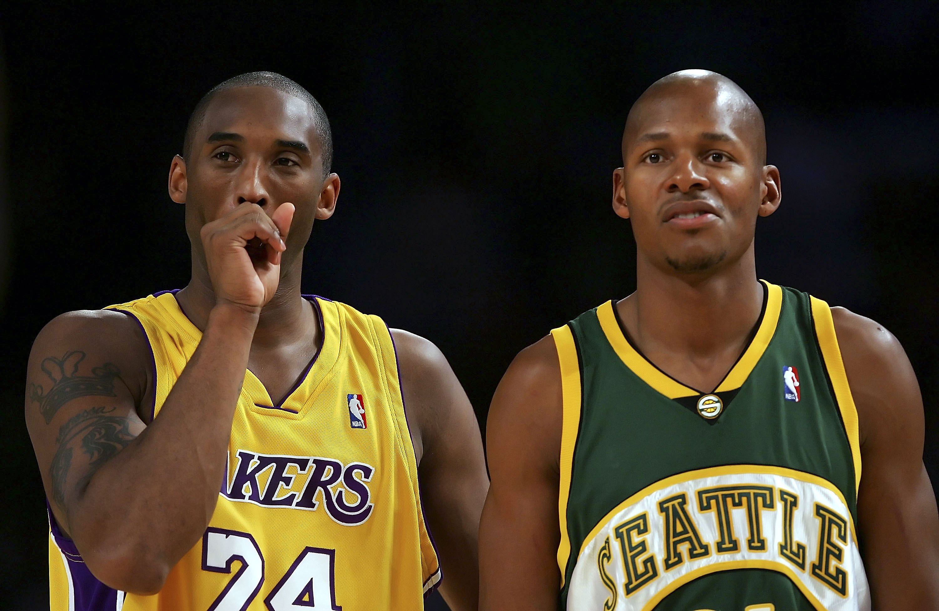 Kobe Bryant stands next to Ray Allen during a 2006 NBA game between the Los Angeles Lakers and Seattle SuperSonics