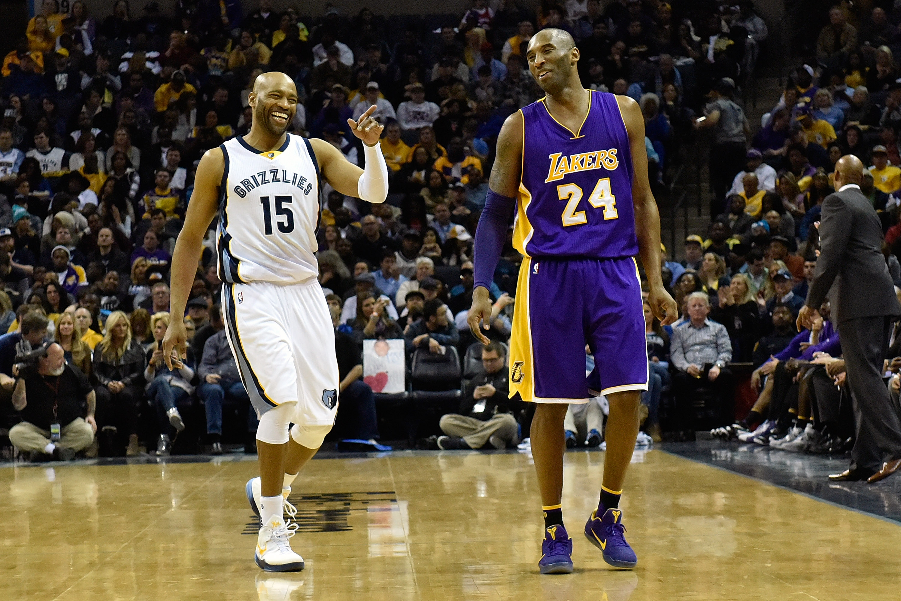 Kobe Bryant and Vince Carter share a laugh during a game between the Los Angeles Lakers and Memphis Grizzlies in February 2016