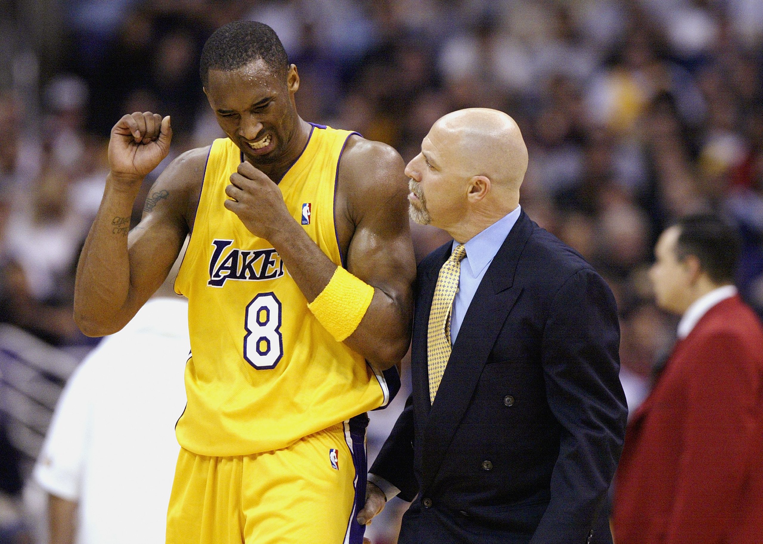 Athletic trainer Gary Vitti talks with Kobe Bryant of the Los Angeles Lakers after an injury.
