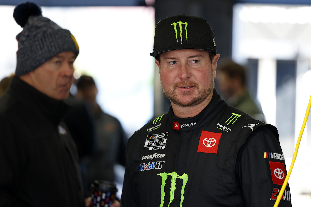 Kurt Busch watches crew work on car