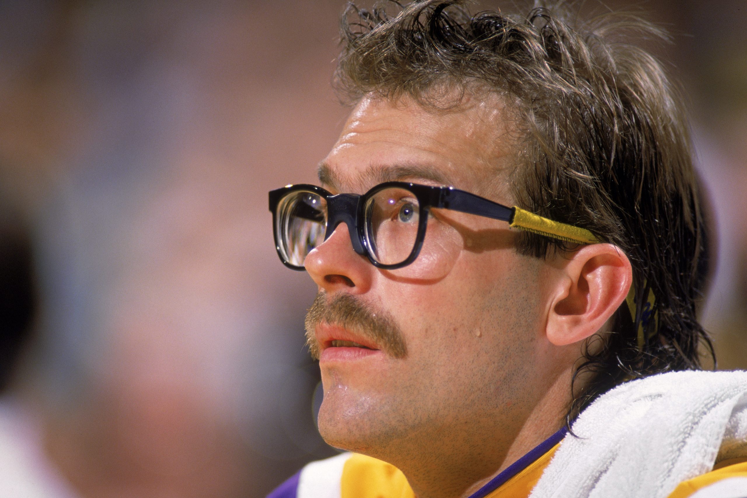 Kurt Rambis of the Los Angeles Lakers sits on the bench.
