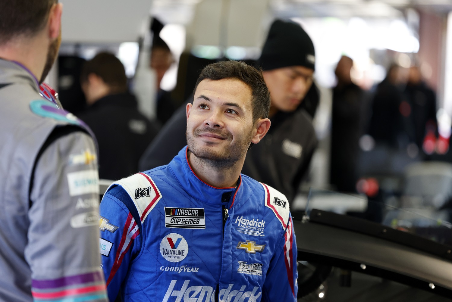 Kyle Larson talks with Hendrick Motorsports teammate Alex Bowman during NASCAR Cup Series Next Gen testing at Charlotte Motor Speedway on Nov. 17, 2021, in Concord, North Carolina.