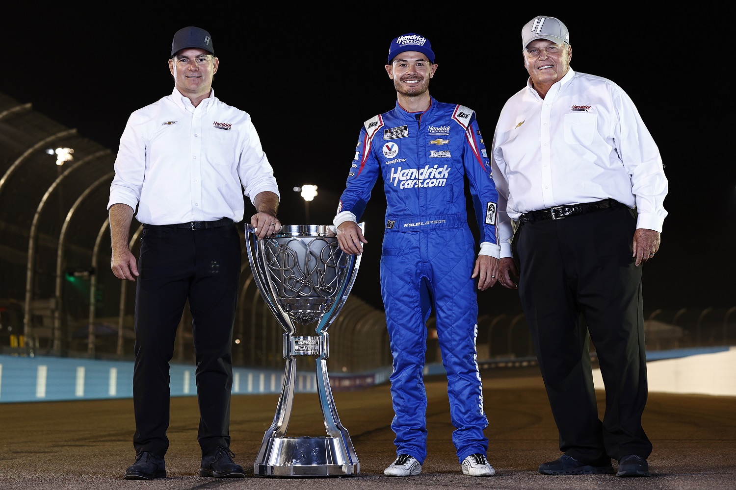 Kyle Larson, driver of the No. 5 Chevy, poses with Jeff Gordon and Rick Hendrick after winning the NASCAR Cup Series championship.