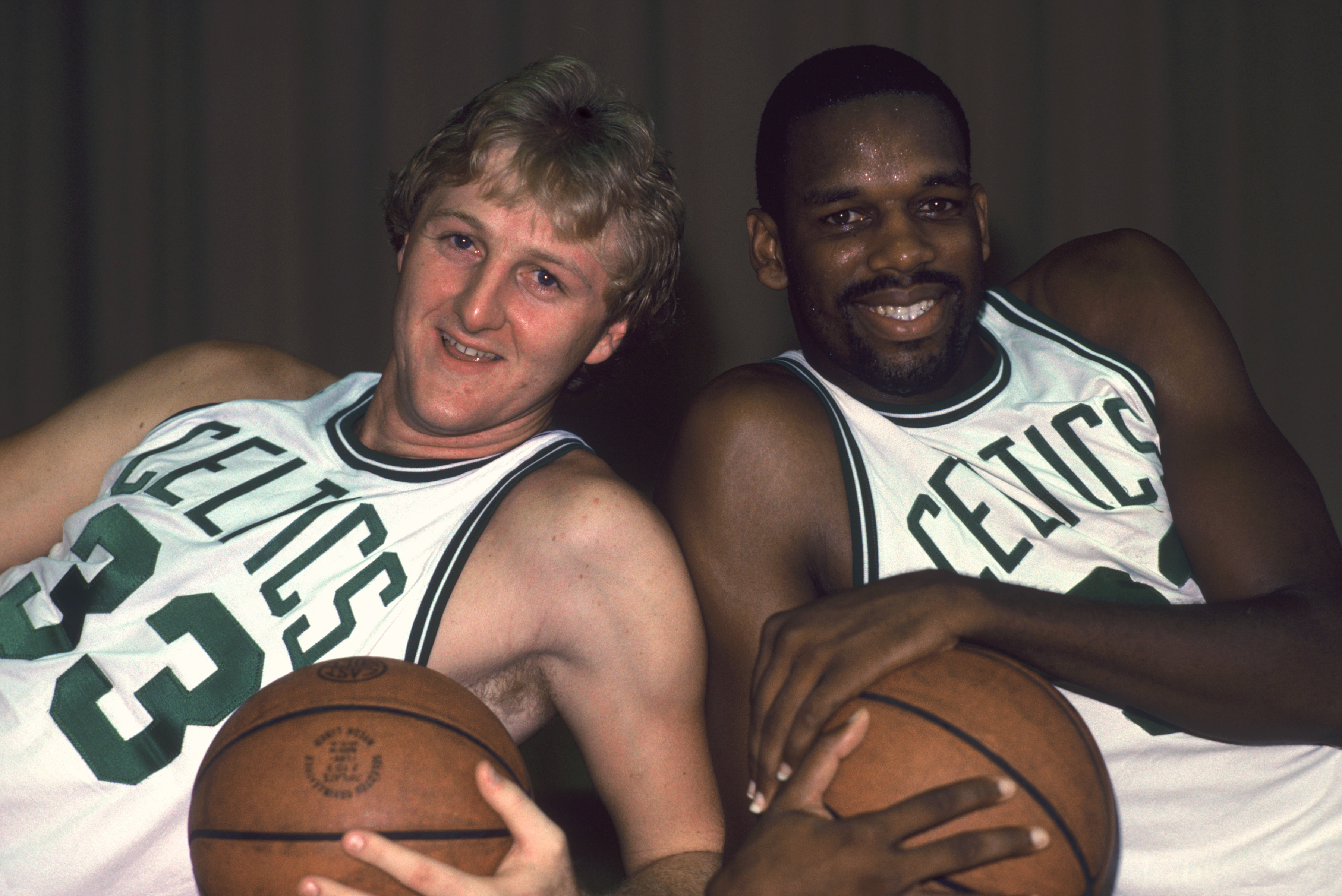 Former Boston Celtics teammates Larry Bird and Cedric Maxwell pose for a photo