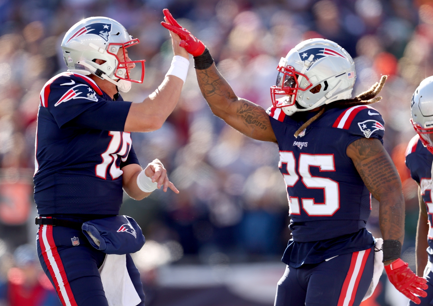 New England Patriots quarterback Mac Jones celebrates a touchdown with teammate Brandon Bolden.