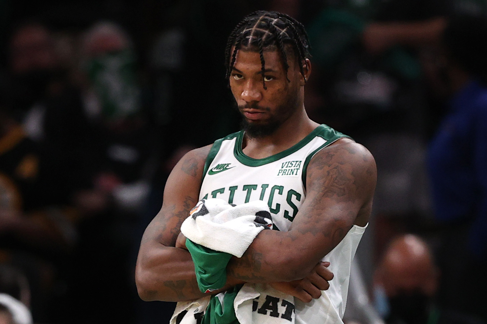 Marcus Smart of the Boston Celtics looks on from the bench during the fourth quarter of the Celtics home opener against the Toronto Raptors.