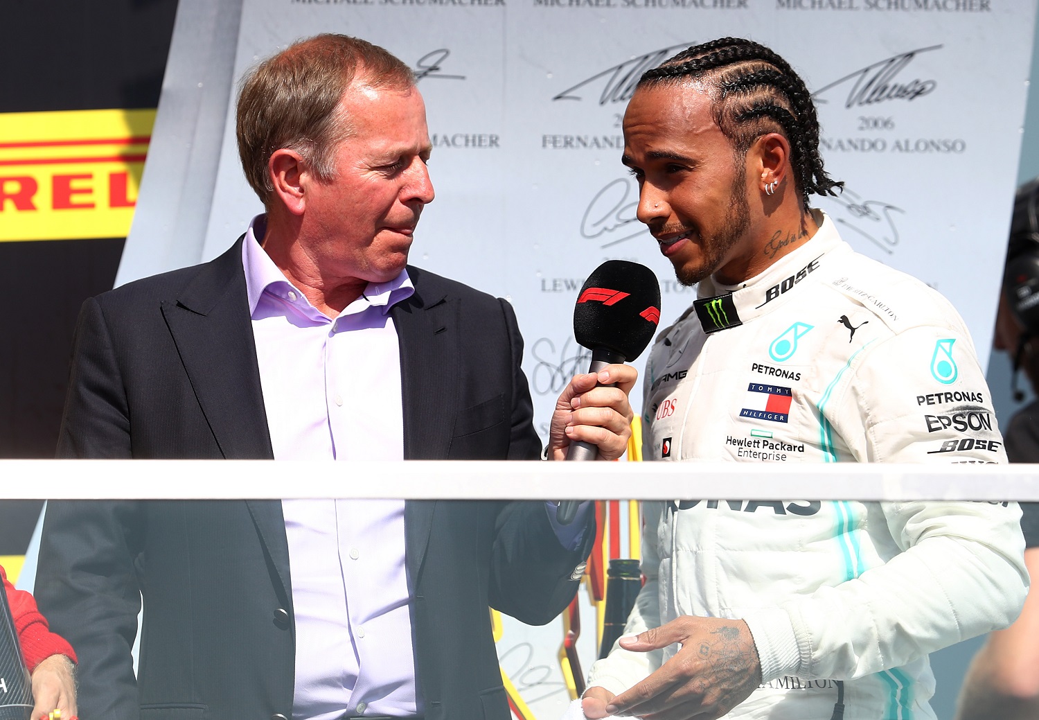 Lewis Hamilton of Great Britain and Mercedes GP talks with Martin Brundle on the podium during the Formula 1 Grand Prix of Canada at Circuit Gilles Villeneuve on June 9, 2019 in Montreal.