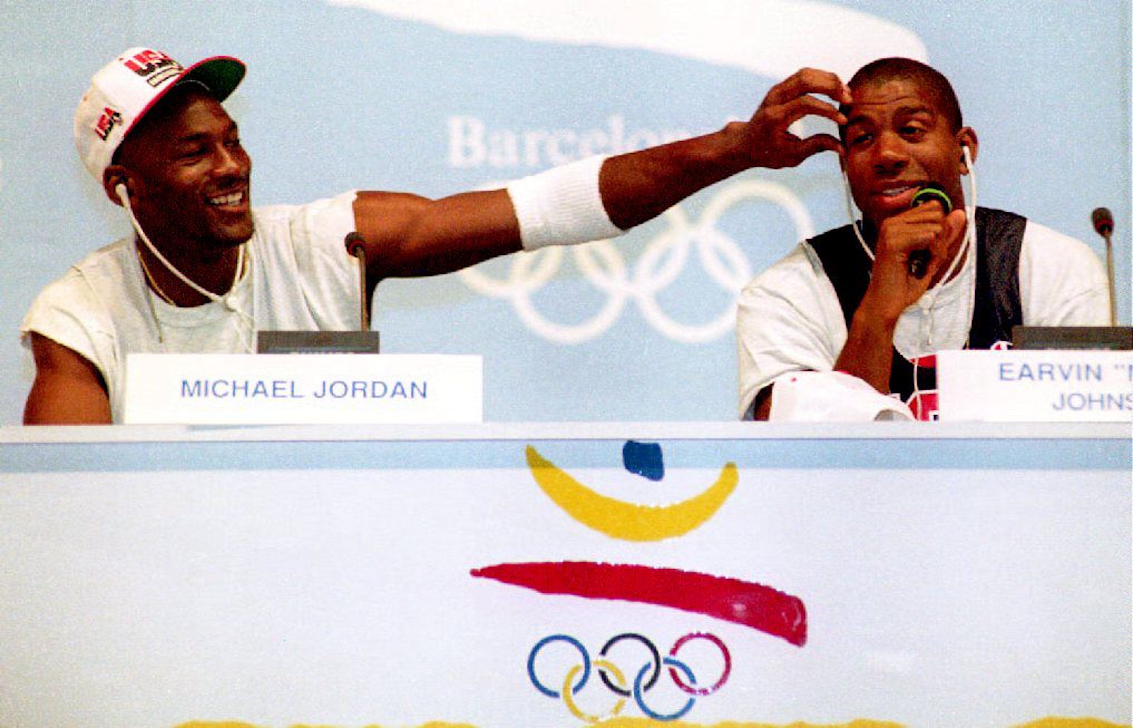 Chicago Bulls legend Michael Jordan jokes with Los Angeles Lakers great Magic Johnson during a Dream Team press conference at the 1992 Olympic Games in Barcelona