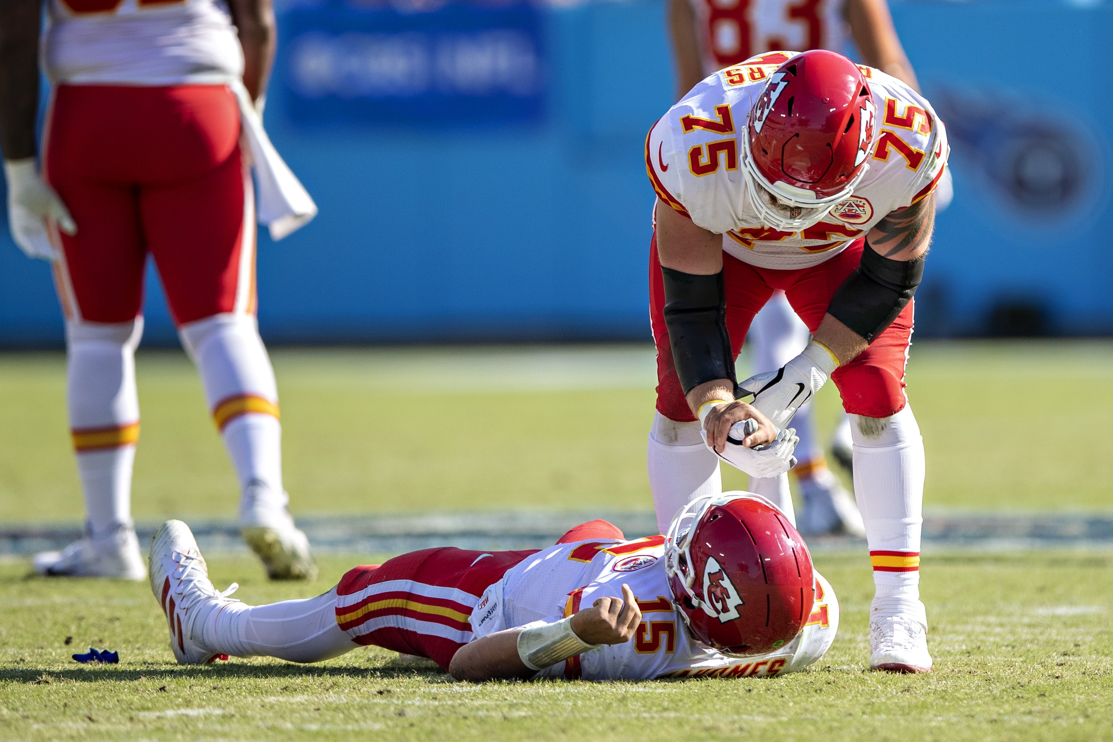 Chiefs offensive lineman Mike Remmers helps up Patrick Mahomes