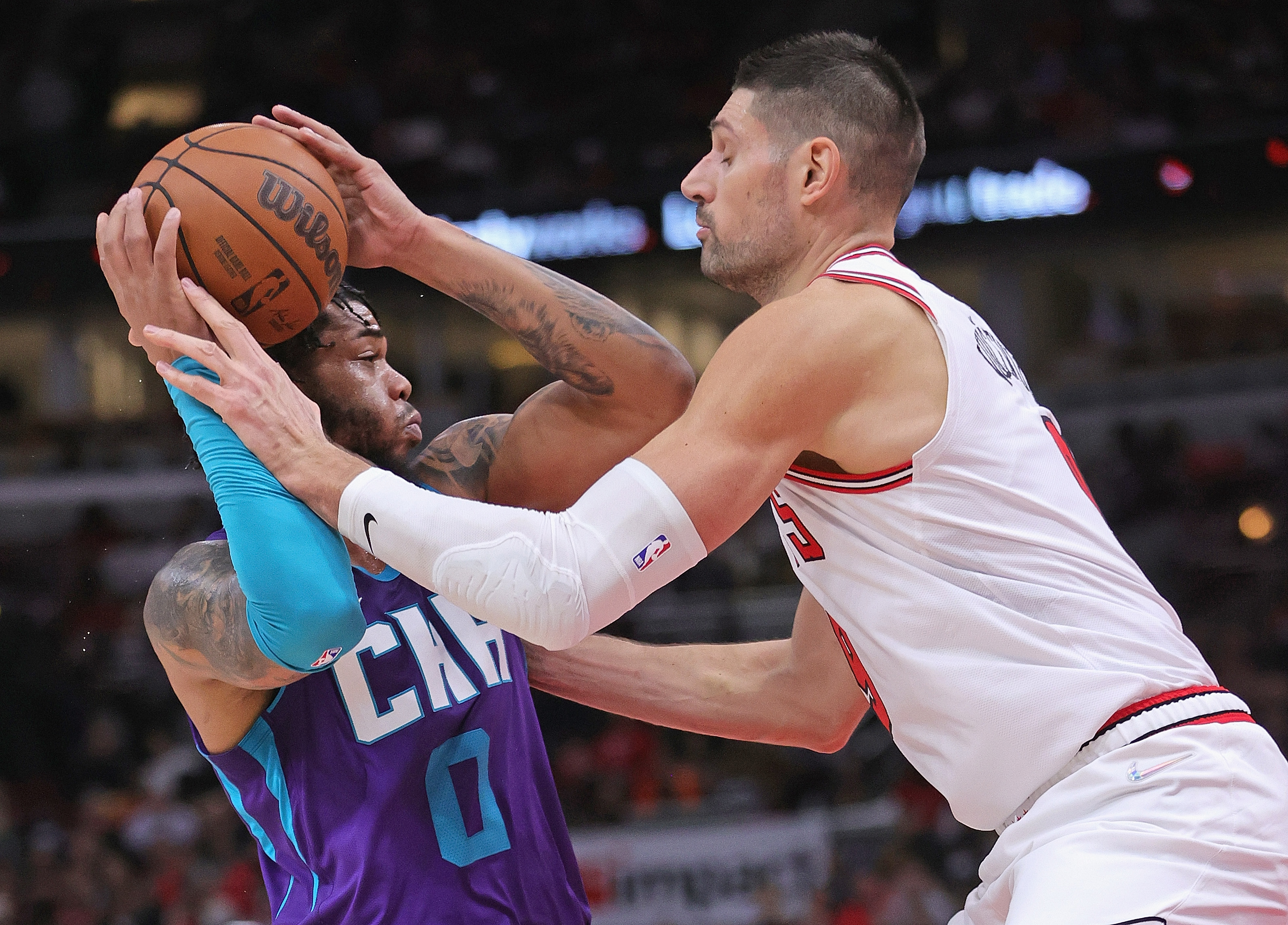 Chicago Bulls center Nikola Vucevic defends Charlotte Hornets forward Miles Bridges