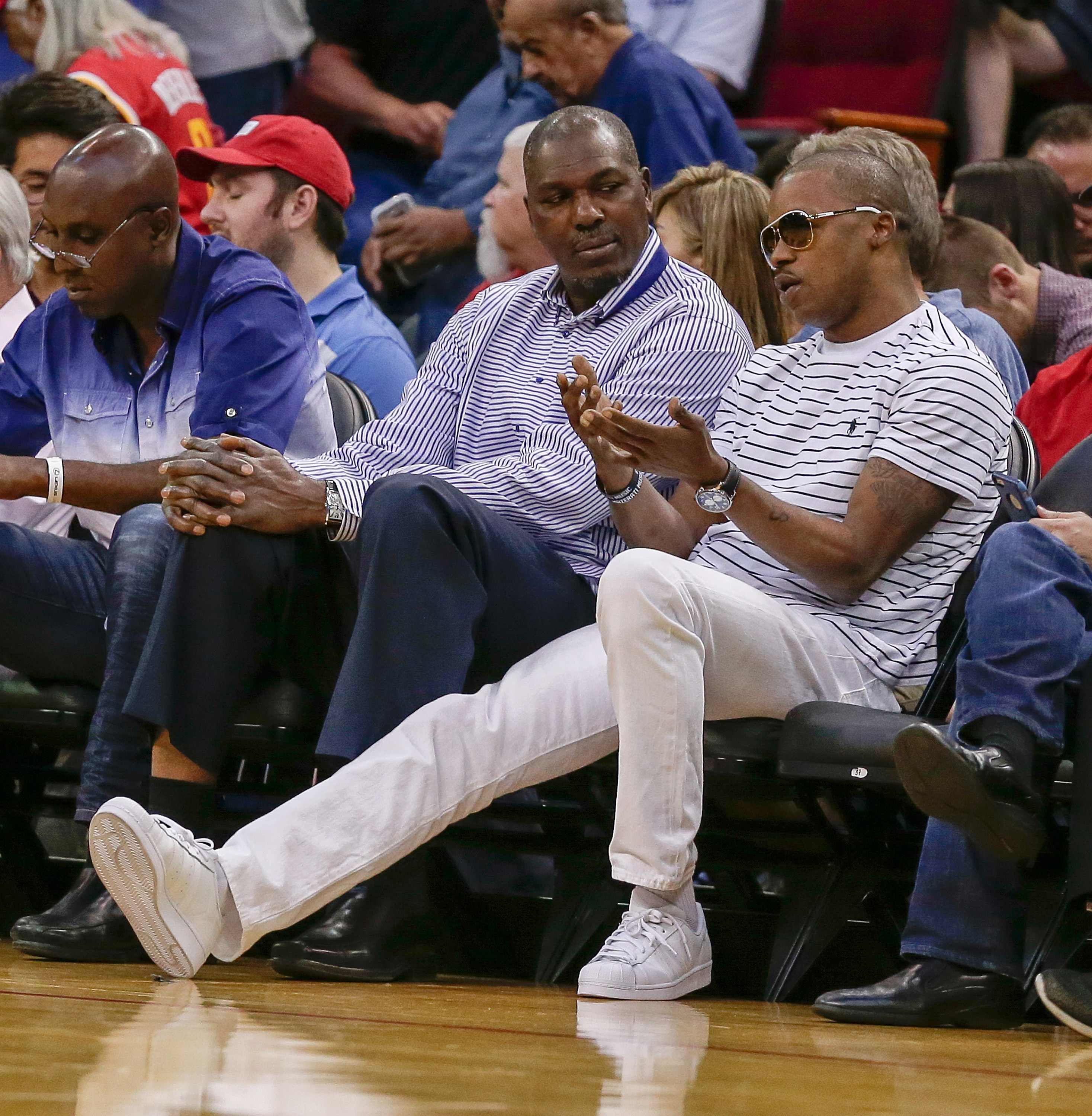 Former Houston Rockets teammates Hakeem Olajuwon and Steve Francis watch in NBA game in 2016