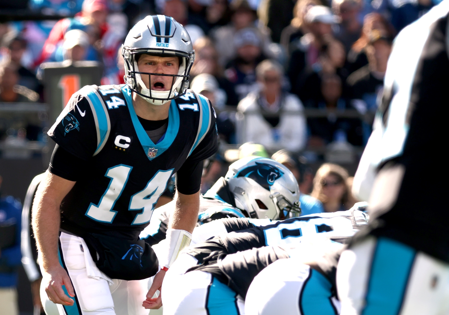 Carolina Panthers quarterback Sam Darnold communicates with teammates before the snap.