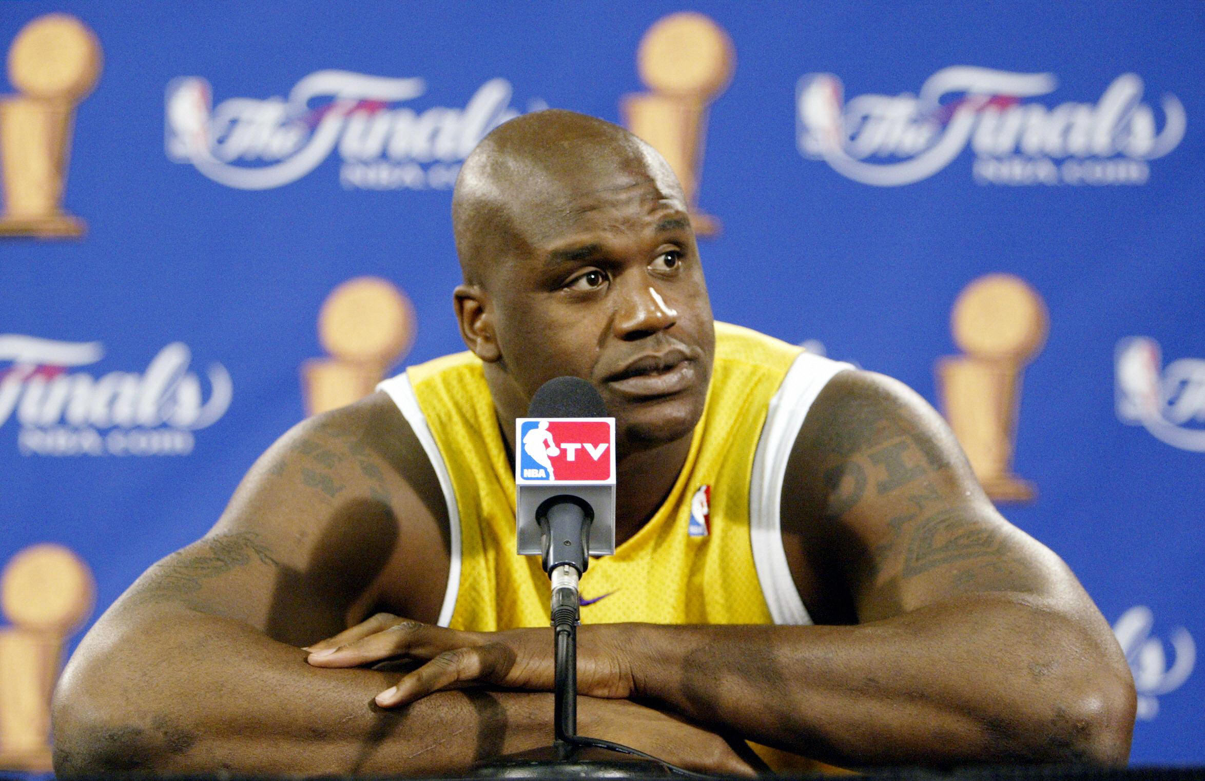 Former Los Angeles Lakers center Shaquille O'Neal answers questions at a press conference during the 2004 NBA Finals
