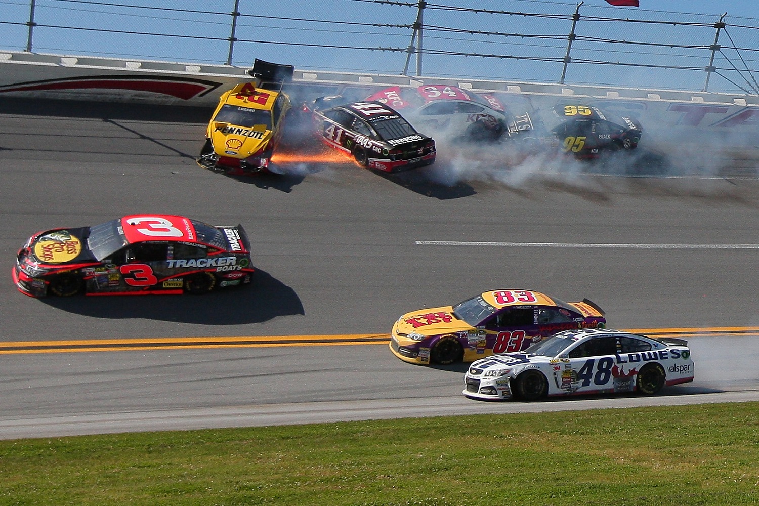 Joey Logano, driver of the No. 22 Ford; Kurt Busch, driver of the No. 41 Chevrolet; David Ragan, driver of the No. 34 Ford; and Michael McDowell, driver of the No. 95 Ford, crash during the NASCAR Sprint Cup Series Aaron's 499 at Talladega Superspeedway on May 4, 2014.