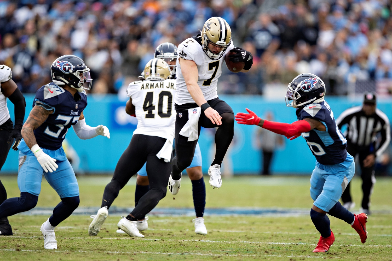New Orleans Saints QB Taysom Hill carries the ball against the Tennessee Titans.