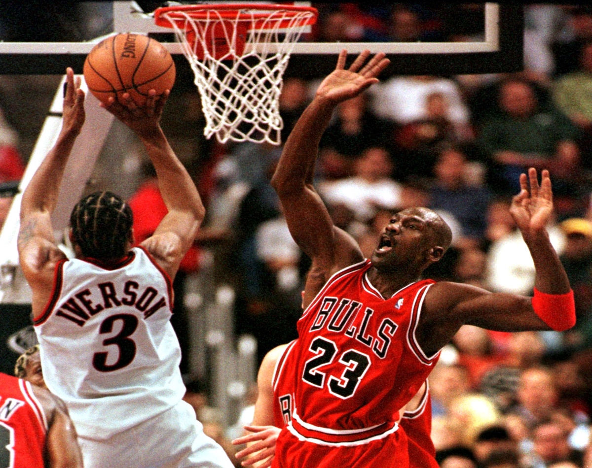 Allen Iverson puts up a shot over Michael Jordan.