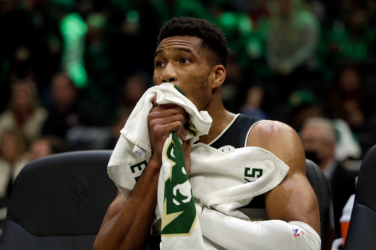 Giannis Antetokounmpo of the Milwaukee Bucks looks on from the bench worried.