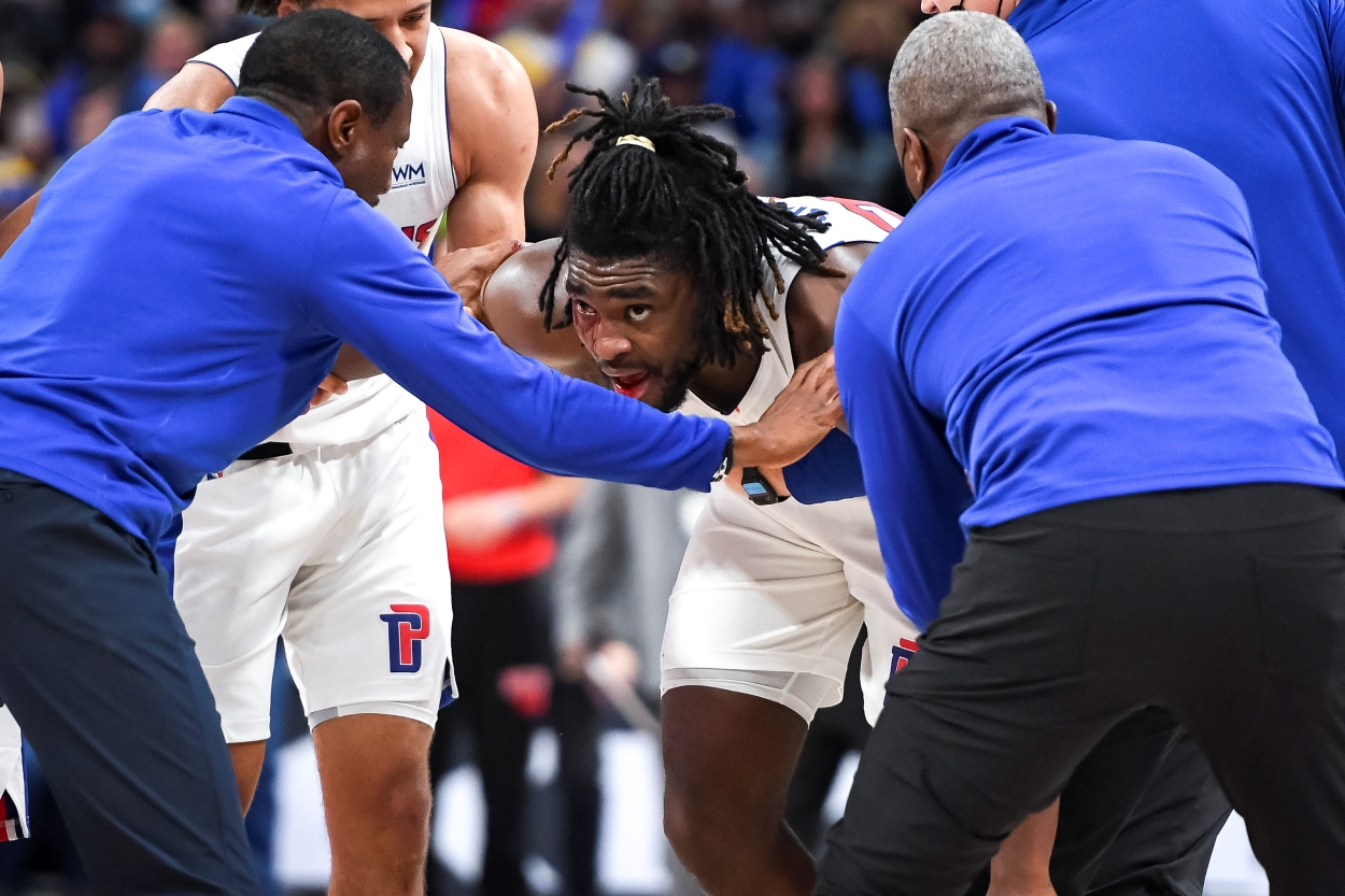 Isaiah Stewart of the Detroit Pistons is restrained after being hit in the face by LeBron James of the Los Angeles Lakers.