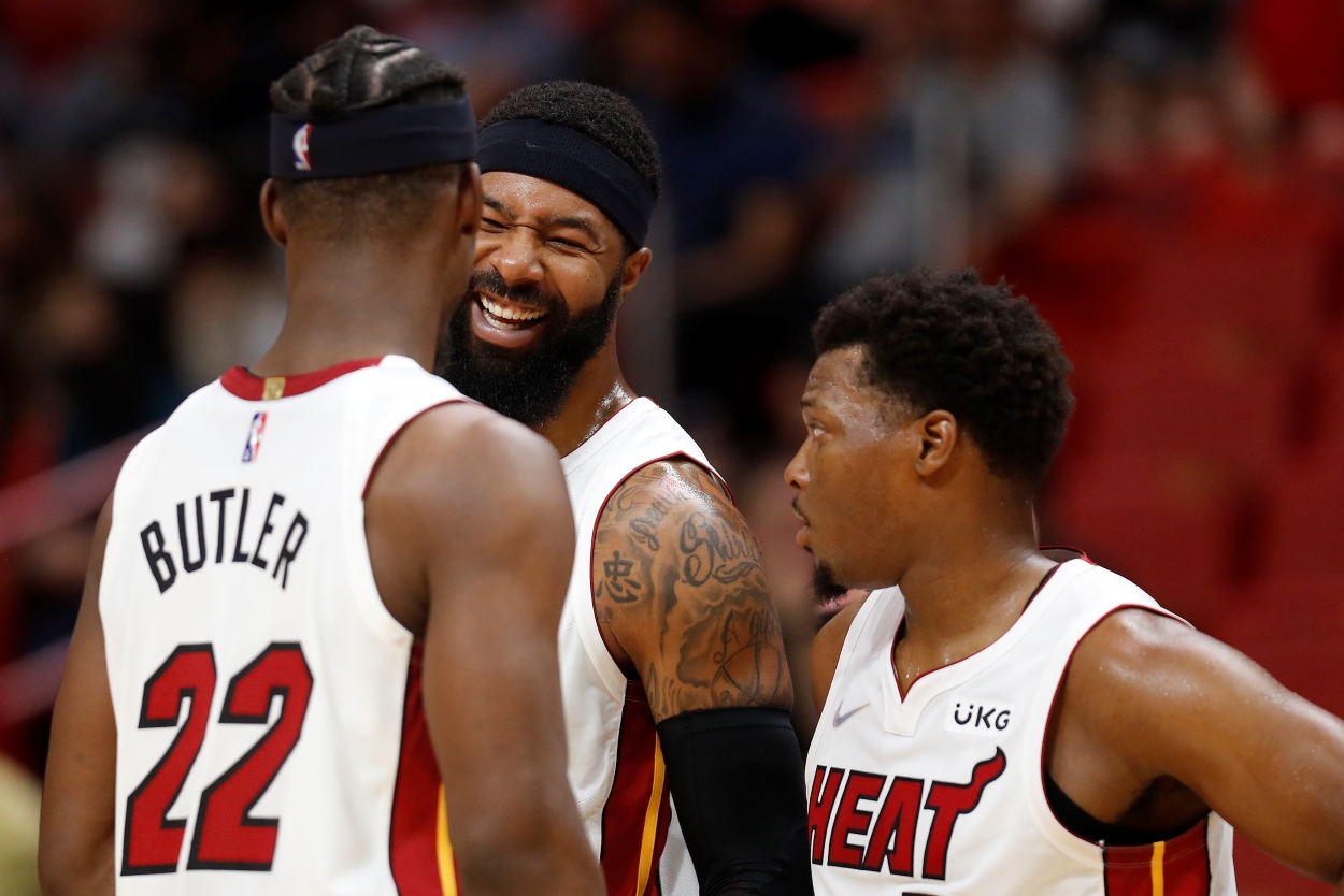 Jimmy Butler and Kyle Lowry, who lead the Miami Heat defense, laugh with teammate Markieff Morris.
