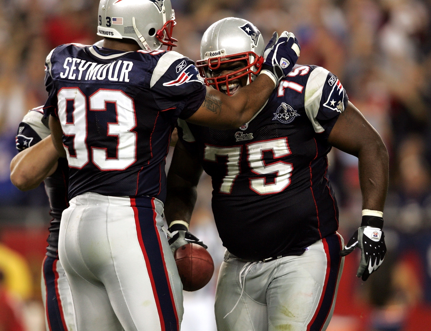 Richard Seymour congratulates New England Patriots teammate Vince Wilfork for recording an interception.