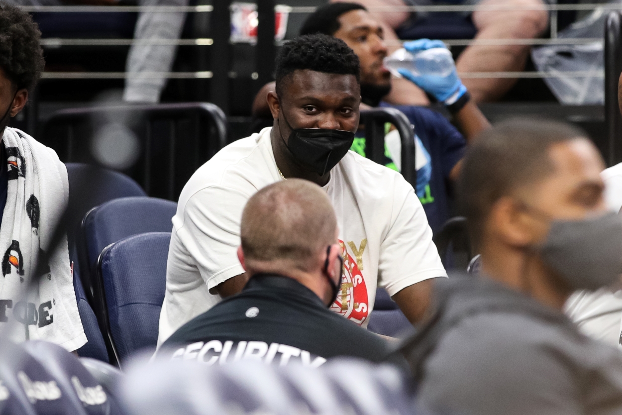 Zion Williamson of the New Orleans Pelicans sits injured on the bench.