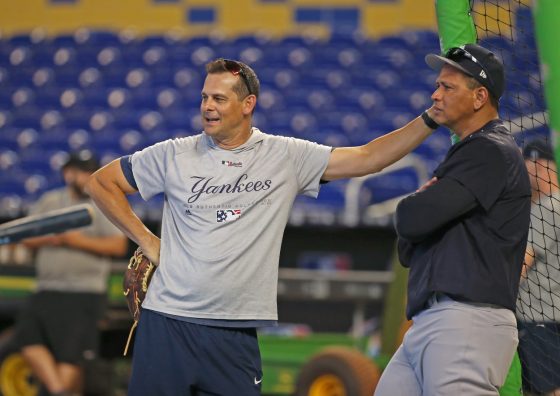 Former New York Yankees player Alex Rodriguez, right, talks with Yankees manager Aaron Boone.