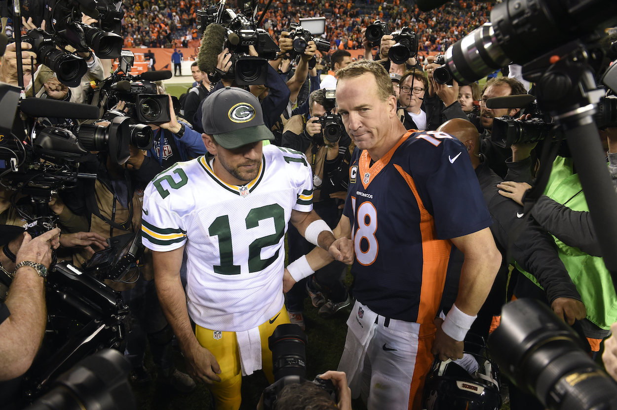 Denver Broncos quarterback Peyton Manning and Green Bay Packers quarterback Aaron Rodgers greet each other following Denver's 29-10 win on Sunday, Nov. 1, 2015, at Sports Authority Field at Mile High Stadium in Denver. Rodgers hinted he may soon appear with Peyton and Eli Manning on the Manning Cast, despite the Manning Cast curse.