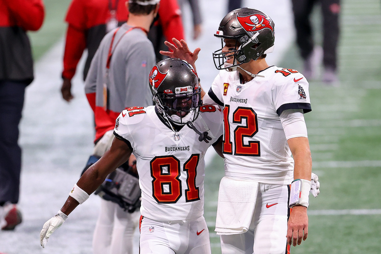 Tom Brady of the Tampa Bay Buccaneers talks with Antonio Brown prior to the game against the Atlanta Falcons at Mercedes-Benz Stadium on December 20, 2020 in Atlanta, Georgia.