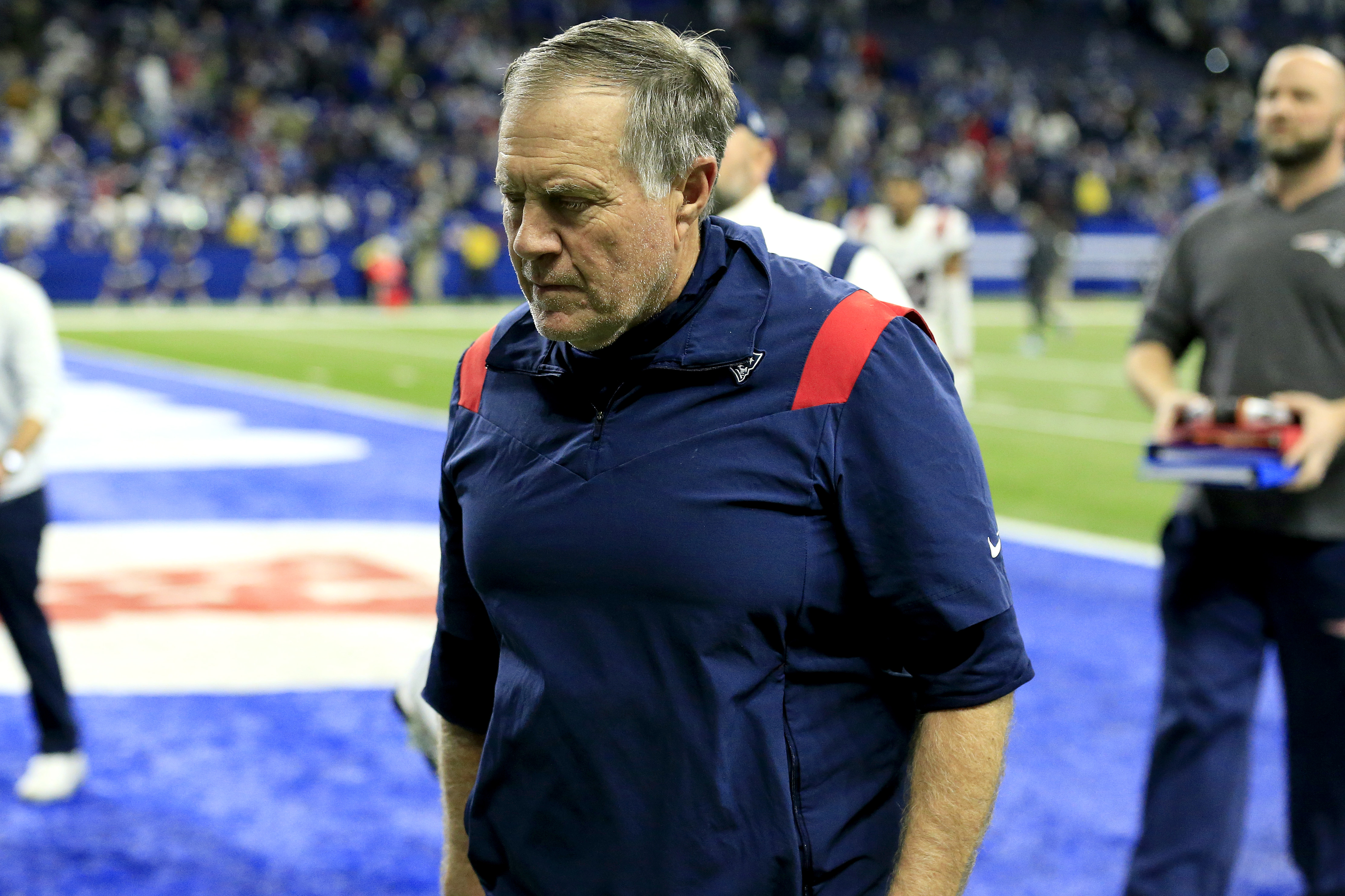 Bill Belichick walks off the field after his Patriots lost to the Colts Saturday