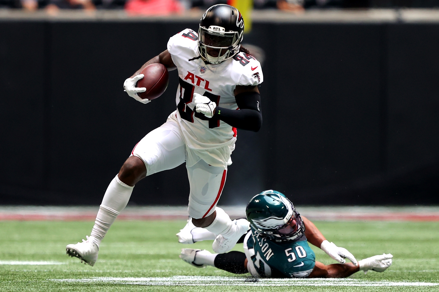 Atlanta Falcons wide receiver Cordarrelle Patterson runs past a diving tackle attempt by a Philadelphia Eagles defender.