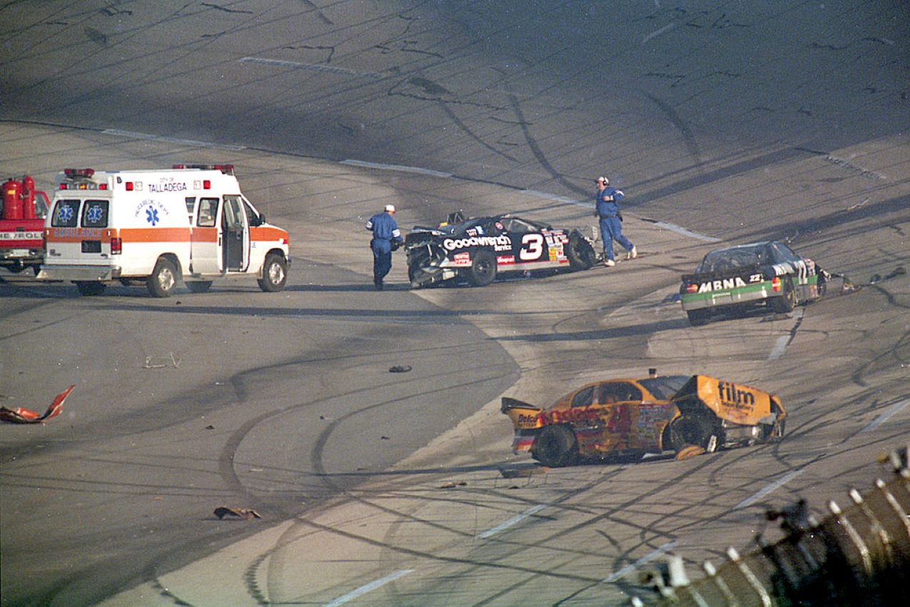 Following an accident during the DieHard 500, track rescue crews rush to the aid of NASCAR Winston Cup drivers Dale Earnhardt Sr. (3), Sterling Marlin (4), and Ward Burton (22) at Talladega Superspeedway on July 28, 1996