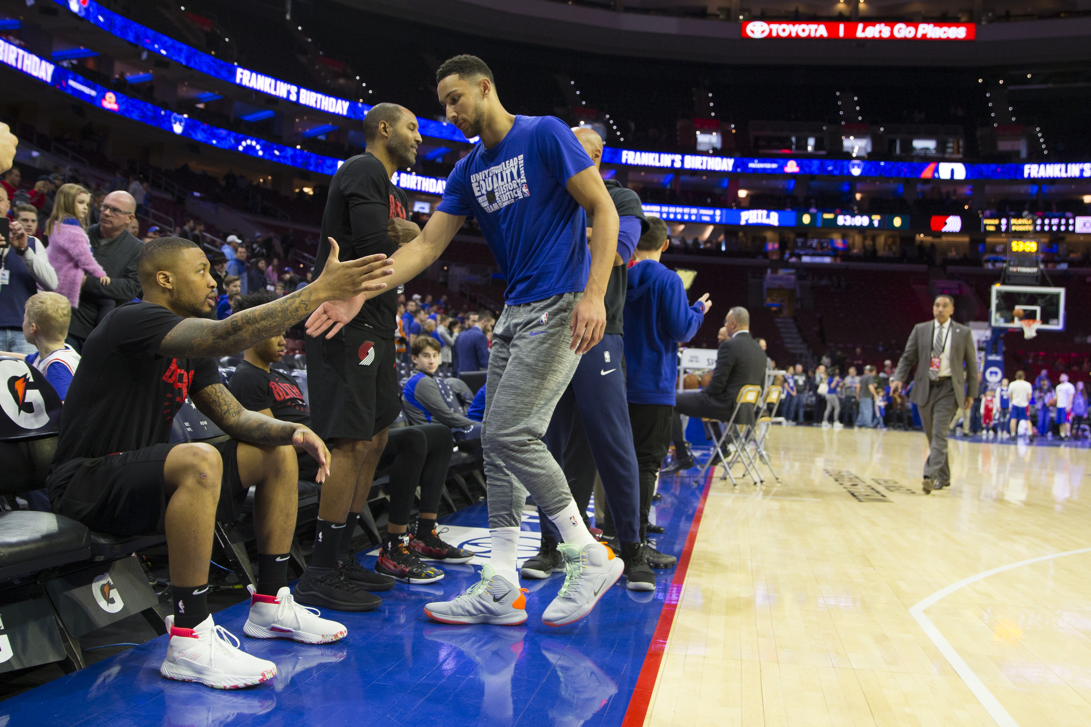 Portland Trail Blazers star guard Damian Lillard shakes hands with Philadelphia 76ers guard Ben Simmons before an NBA game in February 2019
