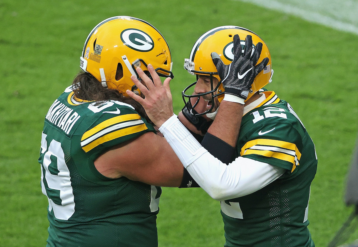 Aaron Rodgers of the Green Bay Packers celebrates a touchdown run with David Bakhtiari in the 2nd quarter against the Jacksonville Jaguars at Lambeau Field on November 15, 2020 in Green Bay, Wisconsin.