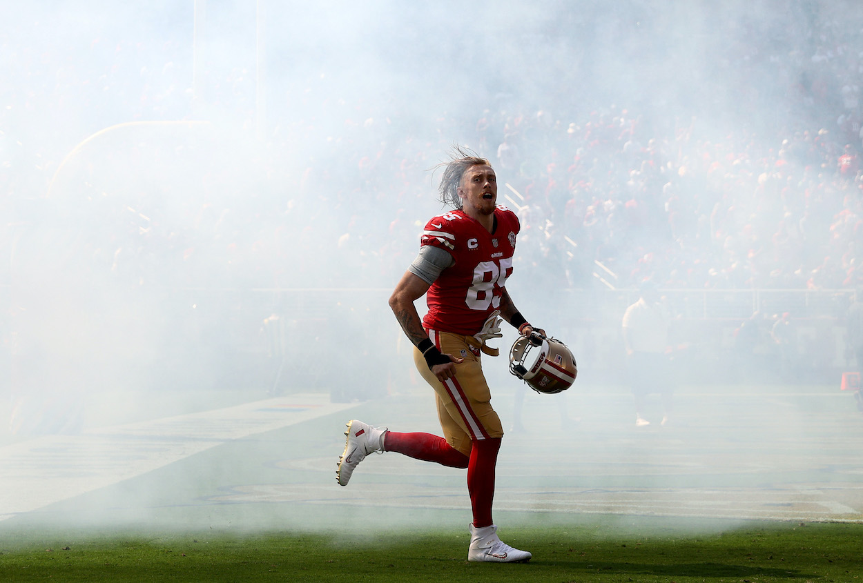 George Kittle of the San Francisco 49ers runs onto the field during player introductions in the game against the Seattle Seahawks at Levi's Stadium on October 03, 2021 in Santa Clara, California.