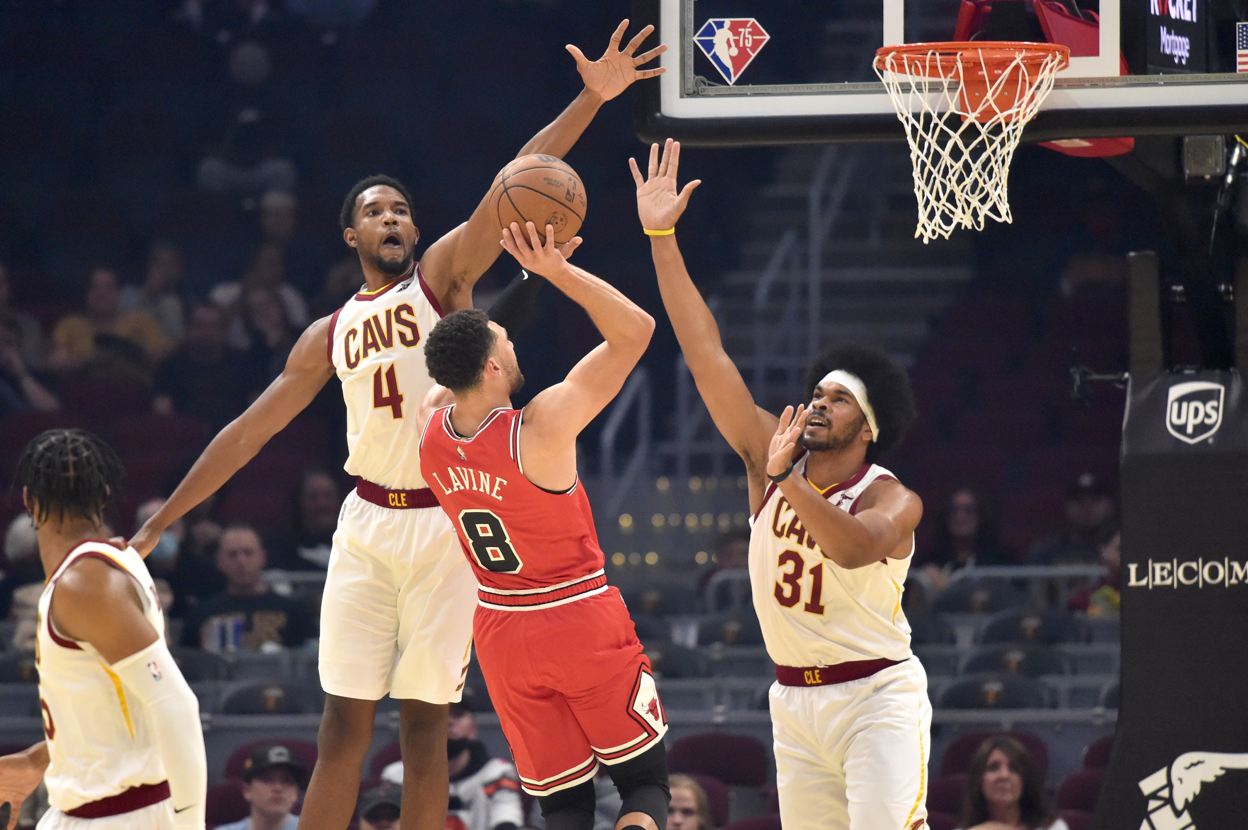 Cleveland Cavaliers bigs Jarrett Allen and Evan Mobley defend Chicago Bulls guard Zach LaVine during an NBA game in October
