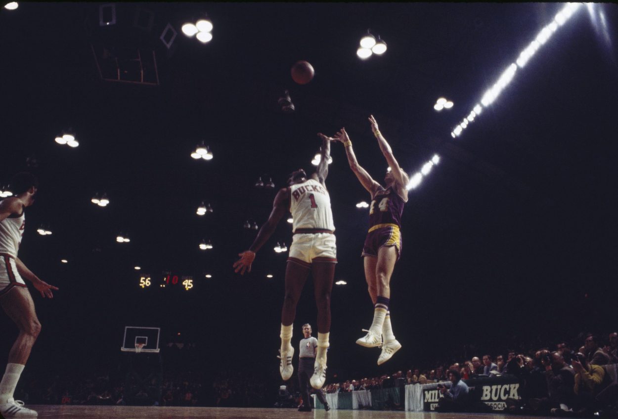 Jerry West shoots over Oscar Robertson during a game between the Los Angeles Lakers and Milwaukee Bucks