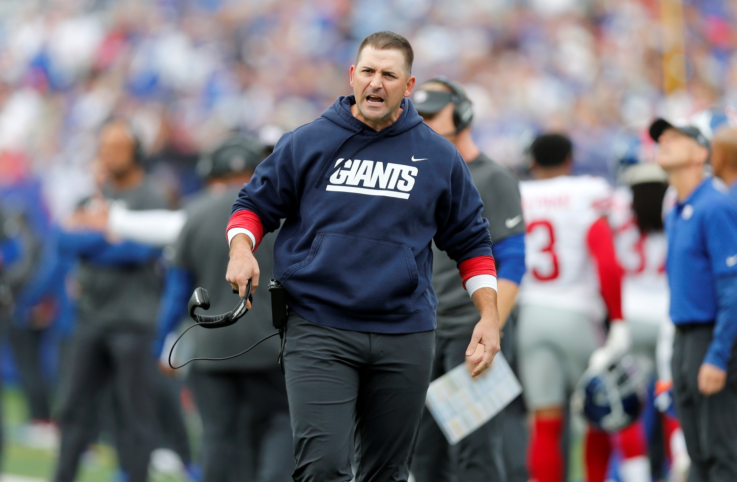 New York Giants head coach Joe Judge reacts angrily to a play during a game.