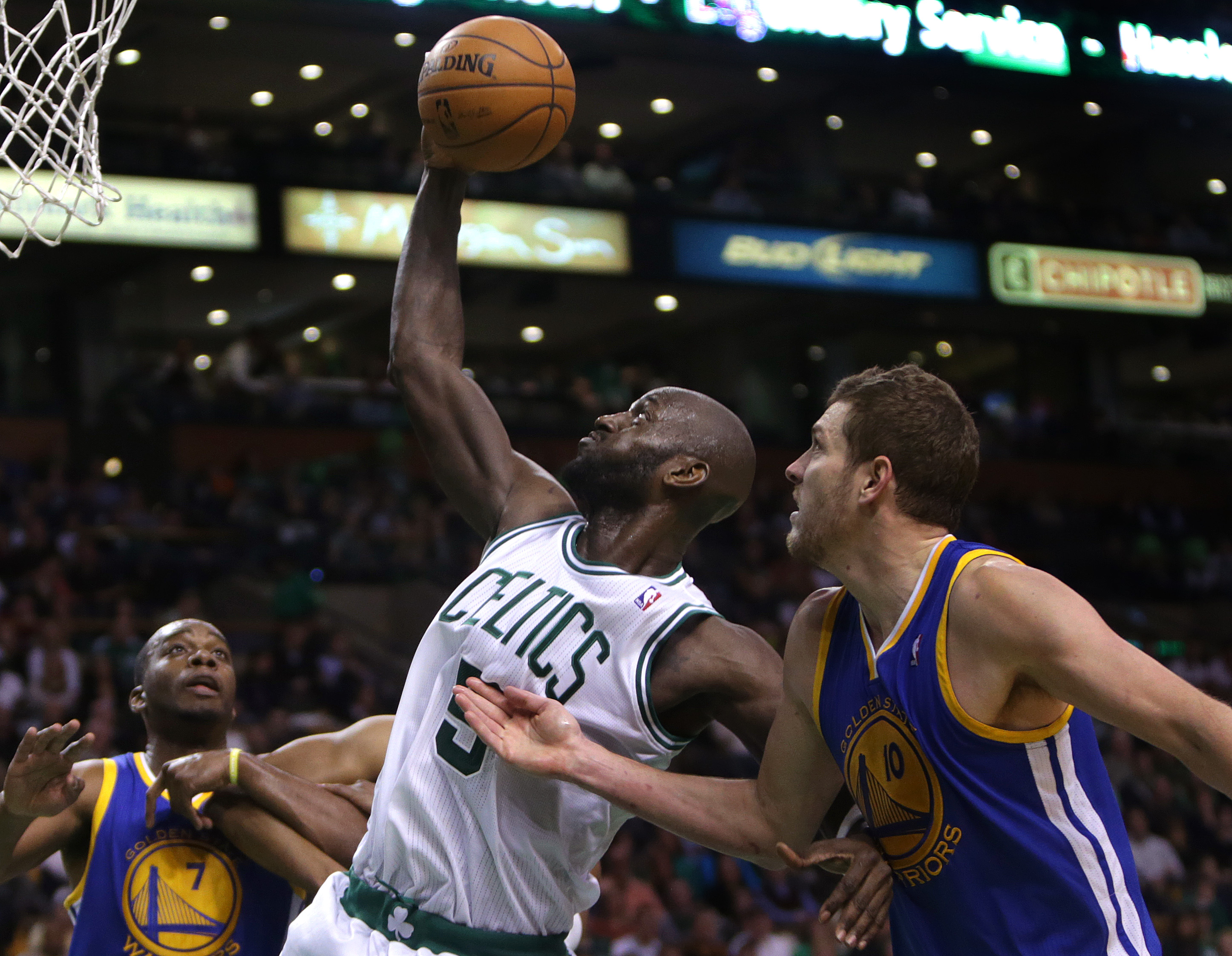 Former Boston Celtics forward Kevin Garnett battles for a rebound during a game against the Golden State Warriors