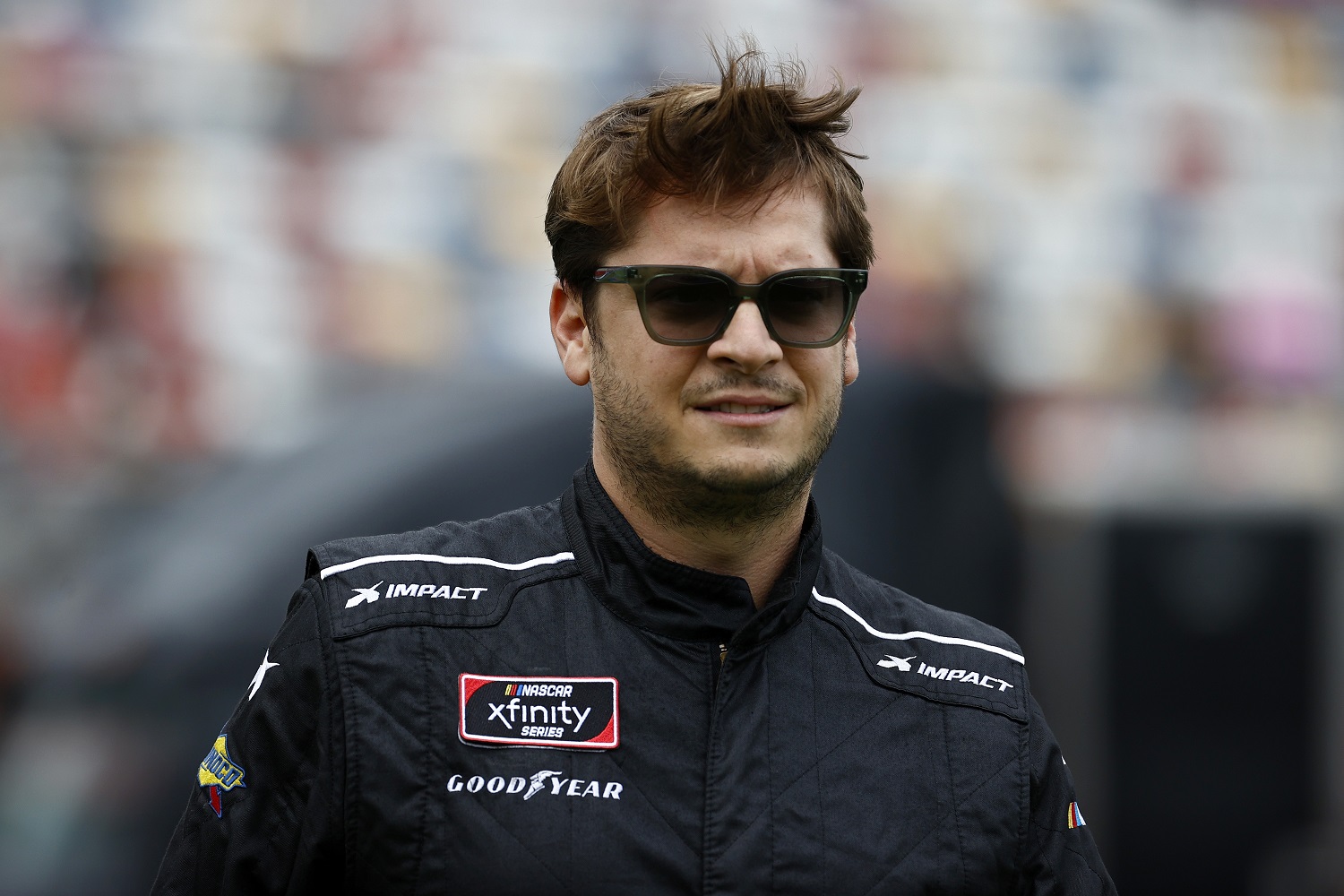 Landon Cassill walks the grid prior to the NASCAR Xfinity Series Drive for the Cure 250 at Charlotte Motor Speedway on Oct. 9, 2021, in Concord, North Carolina. | Jared C. Tilton/Getty Images