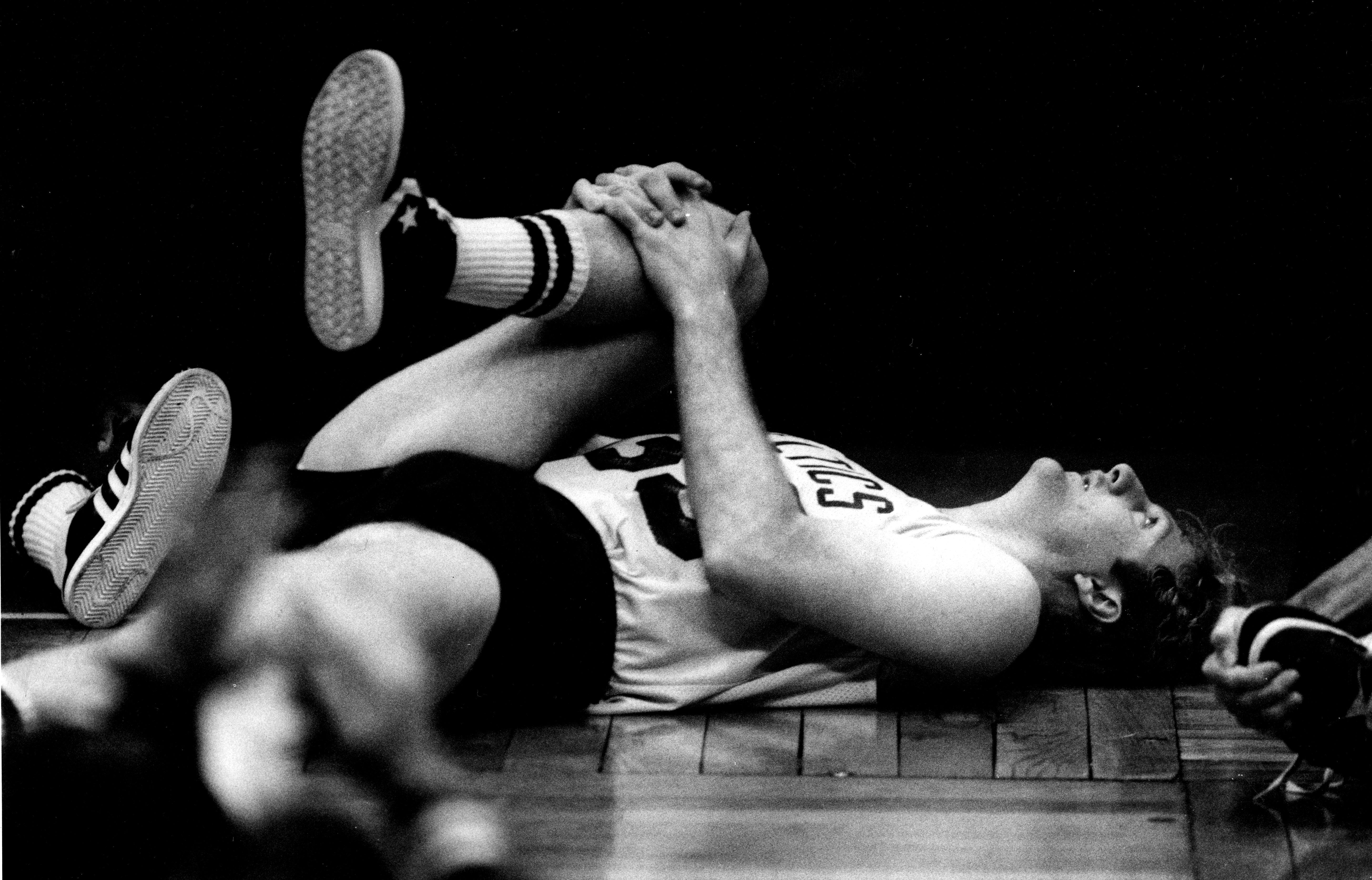 Larry Bird stretches during a Boston Celtics practice in 1985