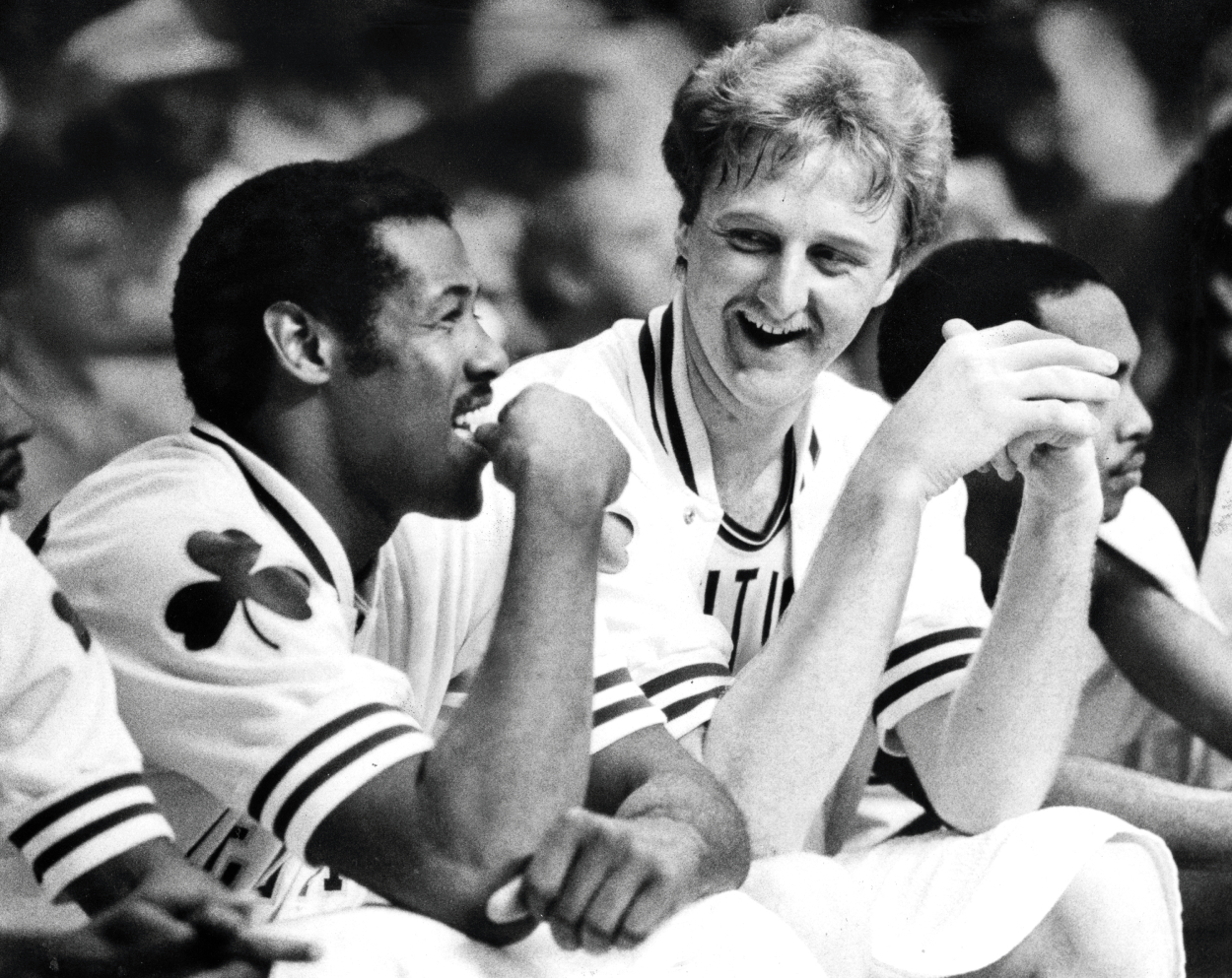 Boston Celtics' M.L. Carr, left, and Larry Bird share a laugh on the bench.