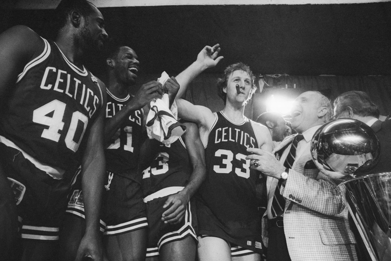 Boston Celtics general manager Red Auerbach laughs after Larry Bird stole his cigar.
