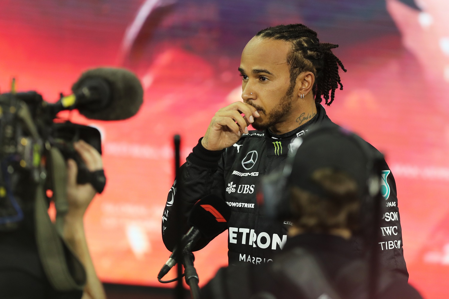 Lewis Hamilton of Mercedes GP talks to the media in parc ferme following the Formula 1 Grand Prix of Abu Dhabi at Yas Marina Circuit on Dec. 12, 2021, in Abu Dhabi, United Arab Emirates.