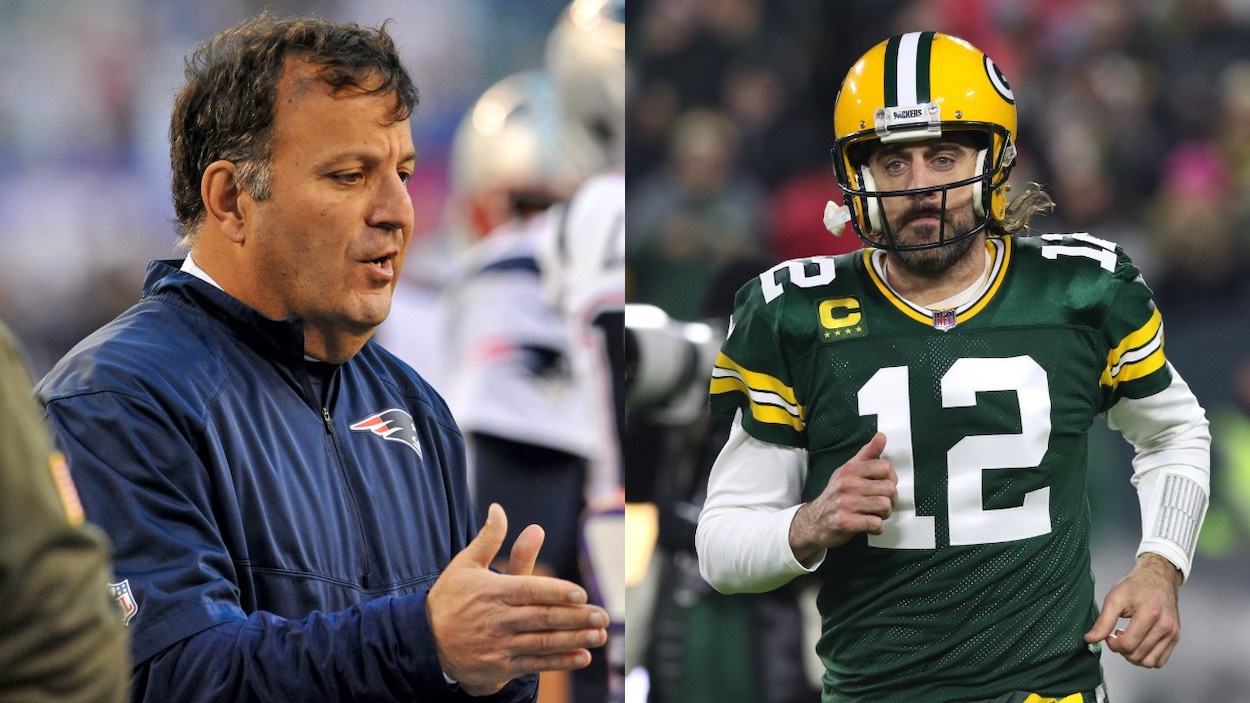 (L-R) Assistant to the coaching staff Michael Lombardi of the New England Patriots on the field prior to a game against the New York Giants at MetLife Stadium on November 15, 2015 in East Rutherford, New Jersey; Green Bay Packers quarterback Aaron Rodgers runs onto the field during a game between the Green Bay Packers and the Chicago Bears at Lambeau Field on December 12, 2021 in Green Bay, WI.