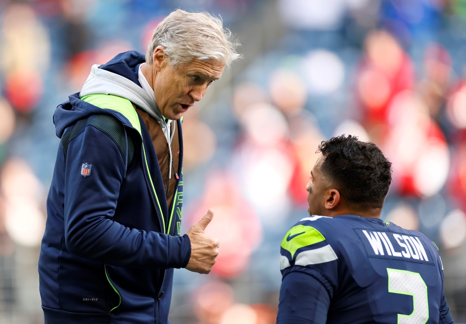 Seattle Seahawks head coach Pete Carroll speaks to quarterback Russell Wilson before a game.