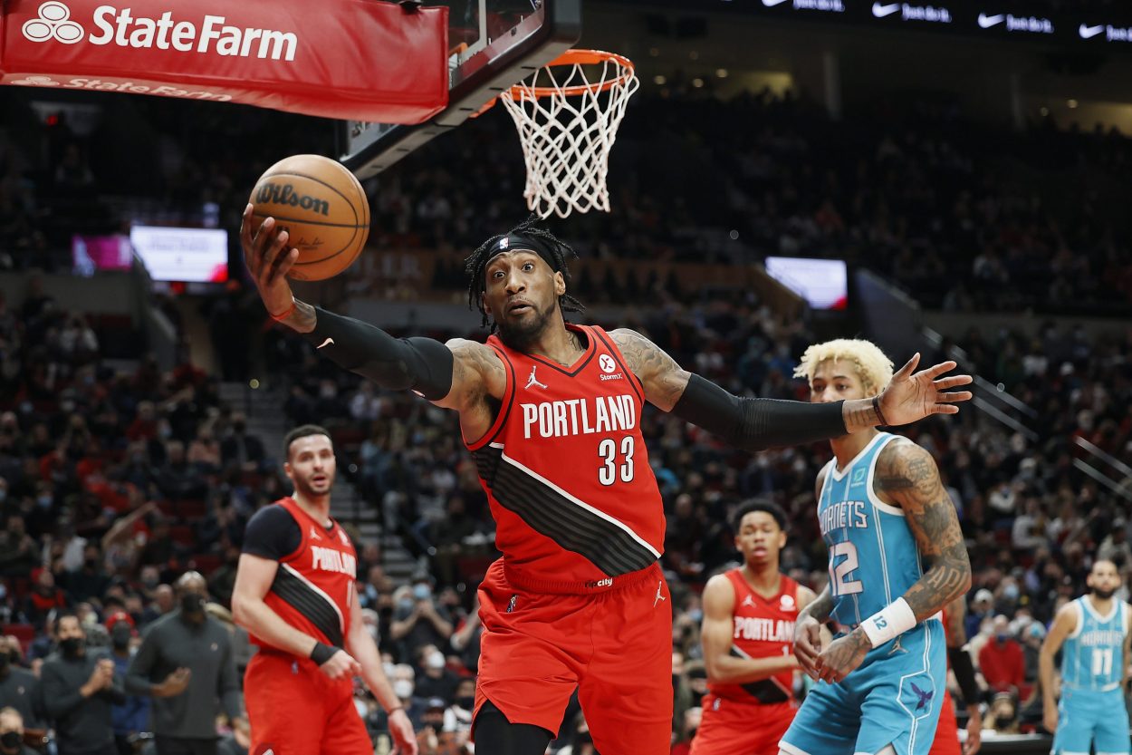 Portland Trail Blazers forward Robert Covington saves a ball during an NBA game against the Charlotte Hornets